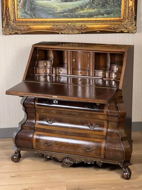 The fall front open, showing the pigeonholes and small drawers inside.