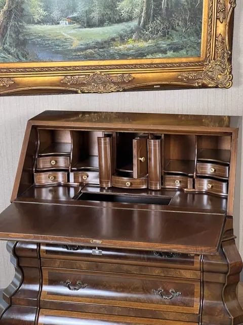The fitted interior straight on, drawers stepped around a centre door.