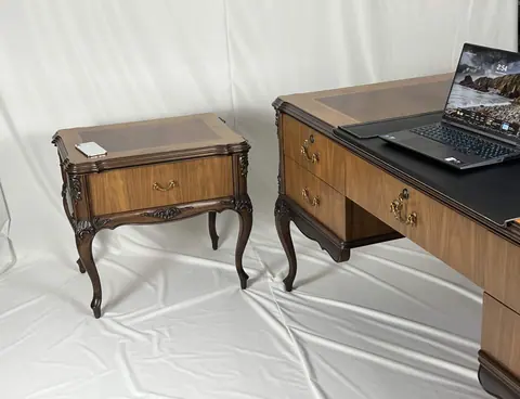 The matching side table standing beside the desk.