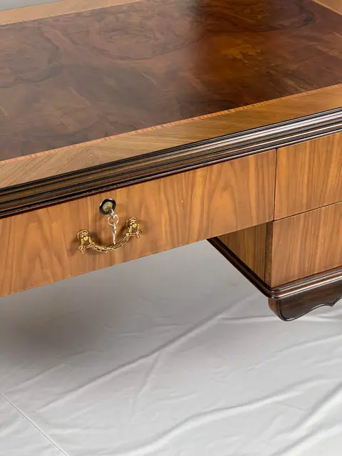 Close view of a drawer front and its brass handle.