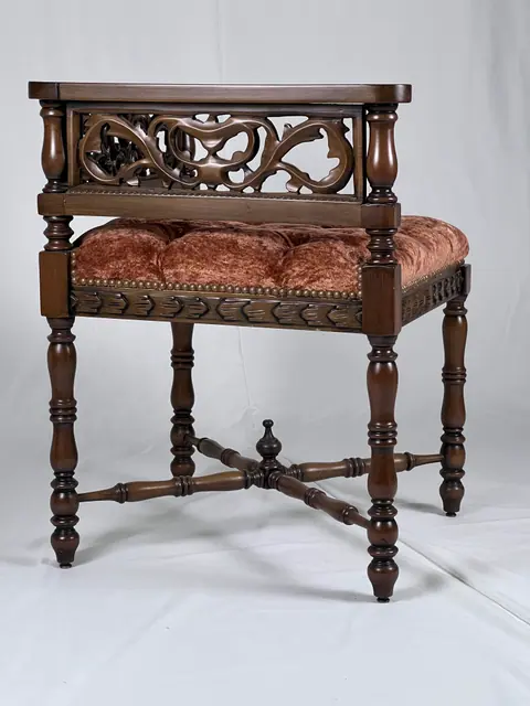 Side view of the corner seat, with turned legs and an X-shaped stretcher.