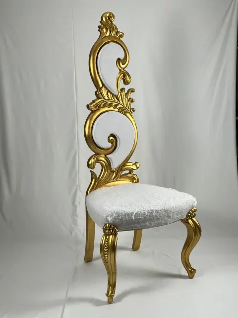 Gilded chair with a tall openwork back and a pale seat.