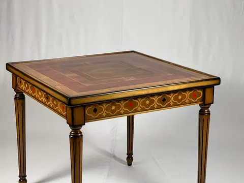 The closed table straight on, standing on four fluted legs.