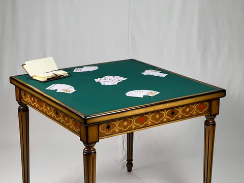 The reverse of the top, lined in green baize for cards.