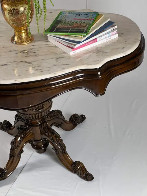 The shaped edge of the marble where it sits on the frame.
