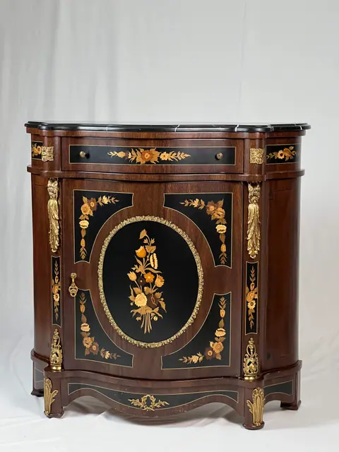 Side cabinet with floral marquetry on a black ground and a dark marble top.