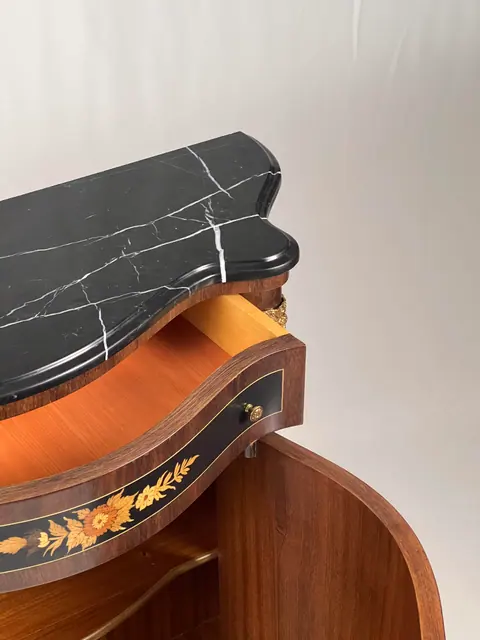 The marble top lifted clear at one end, above an open shelf.