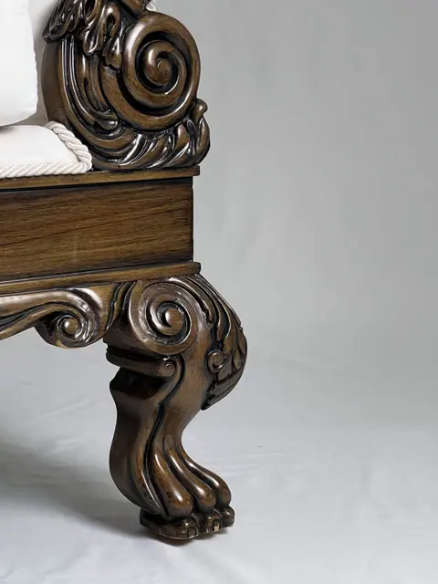 Front leg carved as a paw, with the seat rail above it.