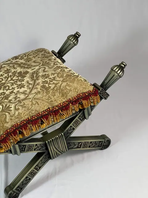 The damask cushion seen from above, fringe running along the edge.