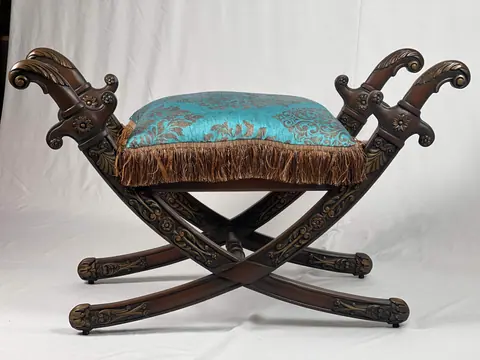 Close view of the cushion and the carved arm ends.