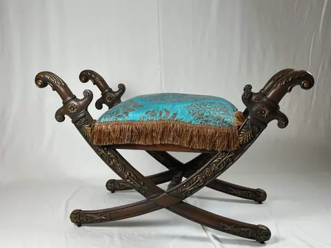 The stool from the other side, fringe hanging over the rail.